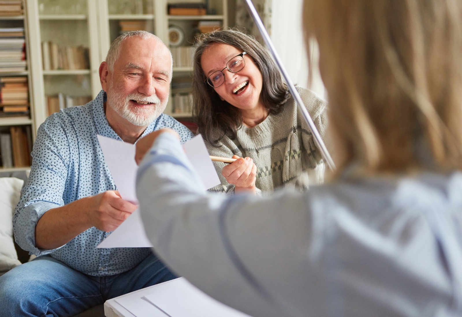persönliche Beratung eines Ehepaares der Mann hält ein Dokument in der Hand